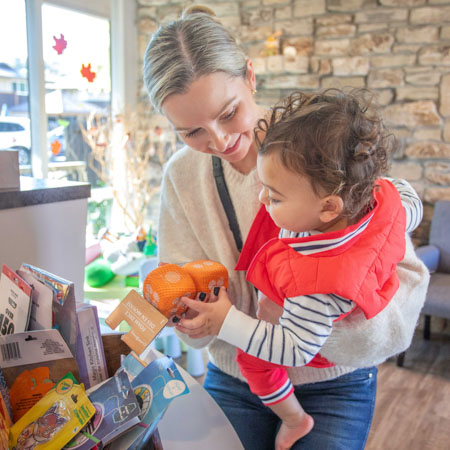 mother showing child a toy