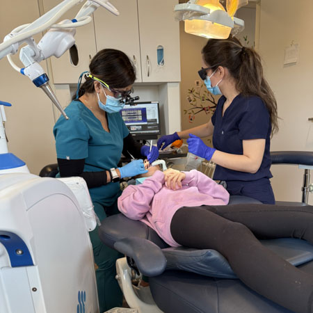 dentist performing cleaning on child